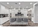 Gourmet kitchen with white cabinetry, stainless steel appliances, and a large island at 220 Glen Lee St, Henderson, NV 89012