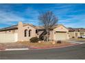 Tan house with arched windows and a pergola at 2540 Sparrow Way, Pahrump, NV 89048