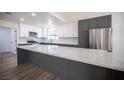 Open kitchen island with white quartz countertop and gray cabinets at 2541 Showcase Dr, Las Vegas, NV 89134