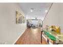 Bright hallway with hardwood floors, leading to living room at 3257 Aiken St, North Las Vegas, NV 89032