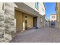 Small backyard patio with gravel and a gate at 3844 Juanita May Ave, North Las Vegas, NV 89032