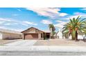 Single story home with brown garage door and gravel landscaping at 3905 Blairmoor St, North Las Vegas, NV 89032