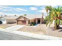 One-story house with brown garage door, desert landscaping, and palm trees at 3905 Blairmoor St, North Las Vegas, NV 89032