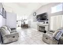 Bright living room featuring tile floors, fireplace, and comfortable seating area at 3905 Blairmoor St, North Las Vegas, NV 89032