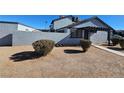 View of the home's side and backyard, showing a small patio area at 4017 Danford Pl, Las Vegas, NV 89102