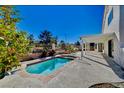 Relaxing kidney-shaped pool with a pergola-covered patio at 5236 Woodlawn Ln, Las Vegas, NV 89130