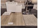 Kitchen design options with white cabinets, quartz countertops, and vinyl plank flooring at 5748 Remy Rain St, Las Vegas, NV 89148