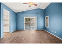 Spacious bedroom featuring wood-look floors and a sliding door to the backyard at 5804 Sassa St, Las Vegas, NV 89130