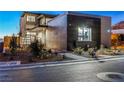 Contemporary home featuring clean lines, complemented by desert landscaping and a paved walkway at 591 Overlook Rim Dr, Henderson, NV 89012