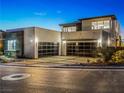 Modern home exterior featuring a multi-car garage, sleek design, and contemporary lighting at 591 Overlook Rim Dr, Henderson, NV 89012