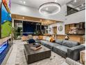 Expansive living room featuring a large sectional sofa, modern fireplace, and sliding doors to the outdoors at 591 Overlook Rim Dr, Henderson, NV 89012