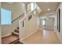 Bright entryway with tiled floors, stairs, and a view of the living room at 5993 Lambert Bridge Ave, Las Vegas, NV 89139