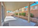 Covered patio with a concrete floor and small plants at 5993 Lambert Bridge Ave, Las Vegas, NV 89139