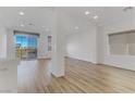 Bright, open-plan living area features stylish wood flooring and recessed lighting at 7075 Jasper Hill Way, Las Vegas, NV 89118