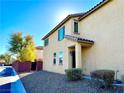 Two-story house with tan exterior, visible front entrance, and landscaping at 7529 Earnshaw Ave, Las Vegas, NV 89149