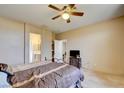 Bedroom with en-suite bathroom and a tv at 7741 Orchard Wood Ct, Las Vegas, NV 89131