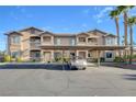 Tan two-story building with carport and palm trees at 8805 Jeffreys St # 1032, Las Vegas, NV 89123