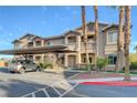 Tan two-story building with carport and palm trees at 8805 Jeffreys St # 1032, Las Vegas, NV 89123