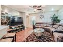 Spacious living room with a large sectional sofa and hardwood floors at 9103 Mcginnis Ave, Las Vegas, NV 89148