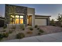 Modern home with stone exterior and landscaped front yard at 928 Calluna Hills Ln, Las Vegas, NV 89138