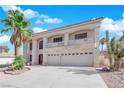 Inviting two-story home featuring a balcony, three-car garage, and mature landscaping at 9852 Snowy Canyon Ct, Las Vegas, NV 89183