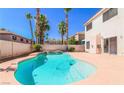 Inviting kidney-shaped pool with waterfall feature in backyard at 9852 Snowy Canyon Ct, Las Vegas, NV 89183