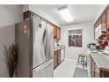 Stainless steel appliances and wood cabinets in this galley kitchen at 5405 Indian River Dr # 392, Las Vegas, NV 89103