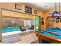 Game room with a pool table and access to a backyard pool at 10093 Golden Bluff Ave, Las Vegas, NV 89148