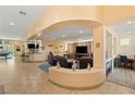 Open living area with a built-in entertainment center and multiple seating areas at 10093 Golden Bluff Ave, Las Vegas, NV 89148