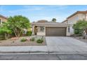 Single-story home with a two-car garage and well-manicured landscaping at 10369 Niagara Falls Ln, Las Vegas, NV 89144