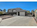 Two-story house with gray exterior, landscaped yard, and driveway at 108 Breeze Ct, Las Vegas, NV 89145