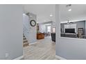 Bright entryway with wood-look floors and views into the living room and kitchen at 10810 Hunters Green Ave, Las Vegas, NV 89166