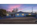 Charming ranch home with updated exterior and landscaping at sunset at 200 Rancho Vista Dr, Las Vegas, NV 89106