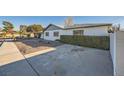 House with a side yard, featuring a gravel driveway and hedges at 200 Rancho Vista Dr, Las Vegas, NV 89106