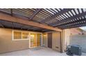 Covered patio with tile flooring, wooden pergola, and access to the interior at 2422 Paradise Village Way, Las Vegas, NV 89104