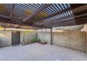 Covered patio with tile flooring, wooden pergola, and gated access at 2422 Paradise Village Way, Las Vegas, NV 89104