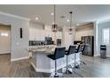 Modern kitchen with granite countertops, white cabinets, and breakfast bar at 2469 Cingoli St, Henderson, NV 89044