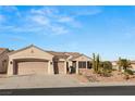 Single story home with two-car garage and desert landscaping at 3110 Scotts Valley Dr, Henderson, NV 89052