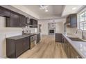 Modern kitchen with dark cabinets, quartz countertops, and stainless steel appliances at 3314 El Camino Real, Las Vegas, NV 89121