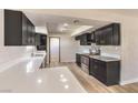 Modern kitchen featuring dark cabinetry, quartz countertops, and stainless steel appliances at 3314 El Camino Real, Las Vegas, NV 89121