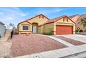 House exterior with orange garage door and rock landscaping at 3434 Empress Diamond Dr, North Las Vegas, NV 89032