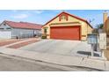 House exterior with orange garage door and rock landscaping at 3434 Empress Diamond Dr, North Las Vegas, NV 89032