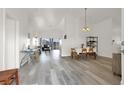 Bright living room with gray vinyl flooring and dining area at 3434 Empress Diamond Dr, North Las Vegas, NV 89032