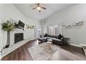 Living room boasts a fireplace, hardwood floors, and an L-shaped sectional sofa at 504 Crony Ave, Henderson, NV 89011