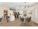 Modern kitchen with white cabinets and a marble dining table at 5305 Singing Hills Dr, Las Vegas, NV 89130