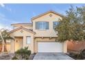 Two-story house with a white garage door and landscaping at 5445 Tallulah Falls St, North Las Vegas, NV 89081