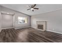 Spacious living room featuring a fireplace and wood-look flooring at 6412 Miragrande Dr, Las Vegas, NV 89108