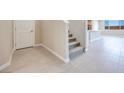 Bright entryway with tiled floor and carpeted stairs at 6828 Pacific Robin St, North Las Vegas, NV 89084