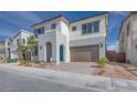 Two-story home with modern design, attached garage, and landscaping at 6828 Pacific Robin St, North Las Vegas, NV 89084