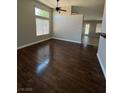 Spacious living room with dark hardwood floors and ceiling fan at 707 Arrowhead Trl, Henderson, NV 89002